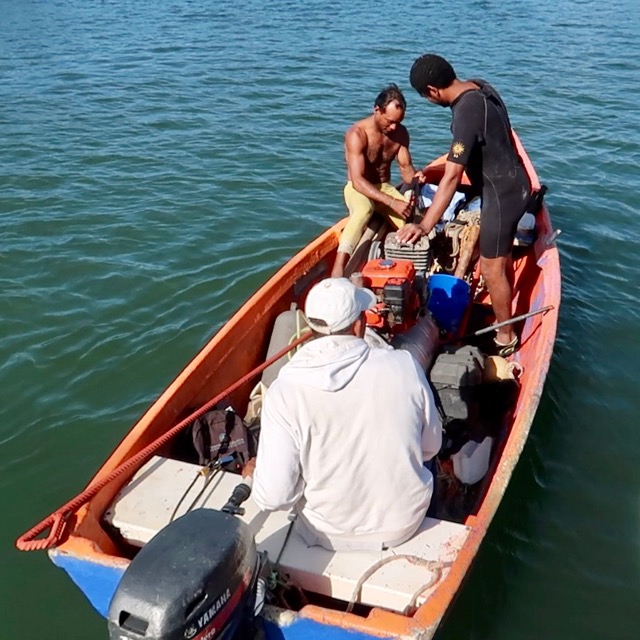Photo of 3 men in a boat