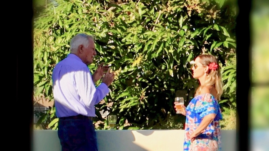 Picture Man and woman standing and having a conversation on an outdoor patio